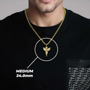 A man wearing a medium gold angel pendant labeled MEDIUM 34.0mm.