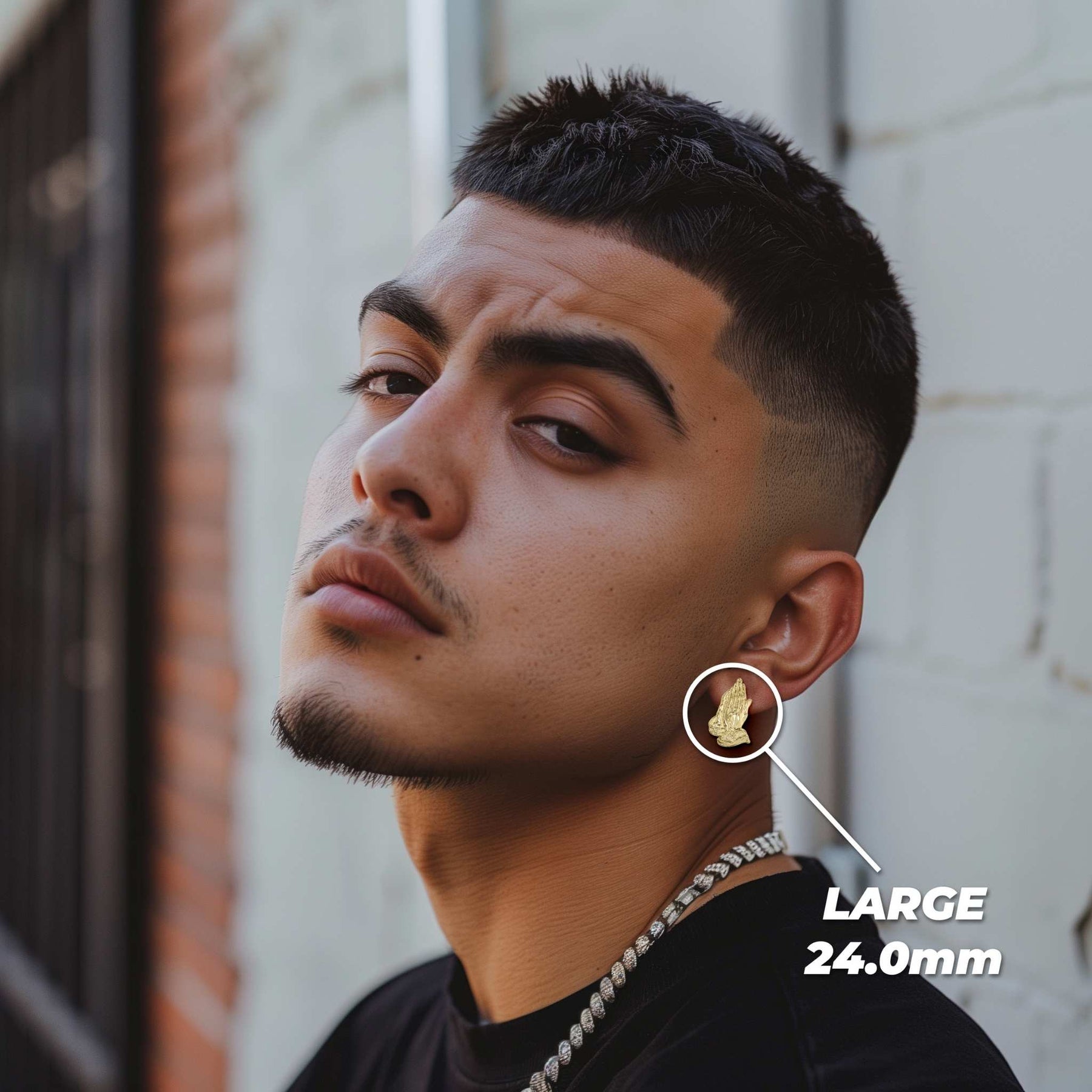Male model wearing large 24.0mm 10k gold praying hands stud earrings.