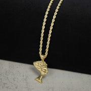 Polished 10k gold Queen Nefertiti pendant on a rope chain against a split background.
