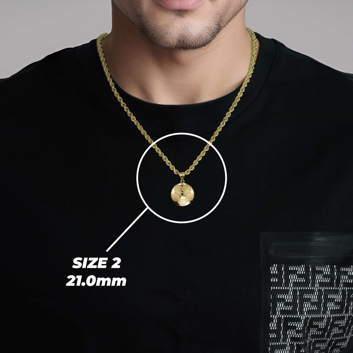 A man wearing a medium 10k gold classic soccer ball pendant and size 2 label on a black shirt.