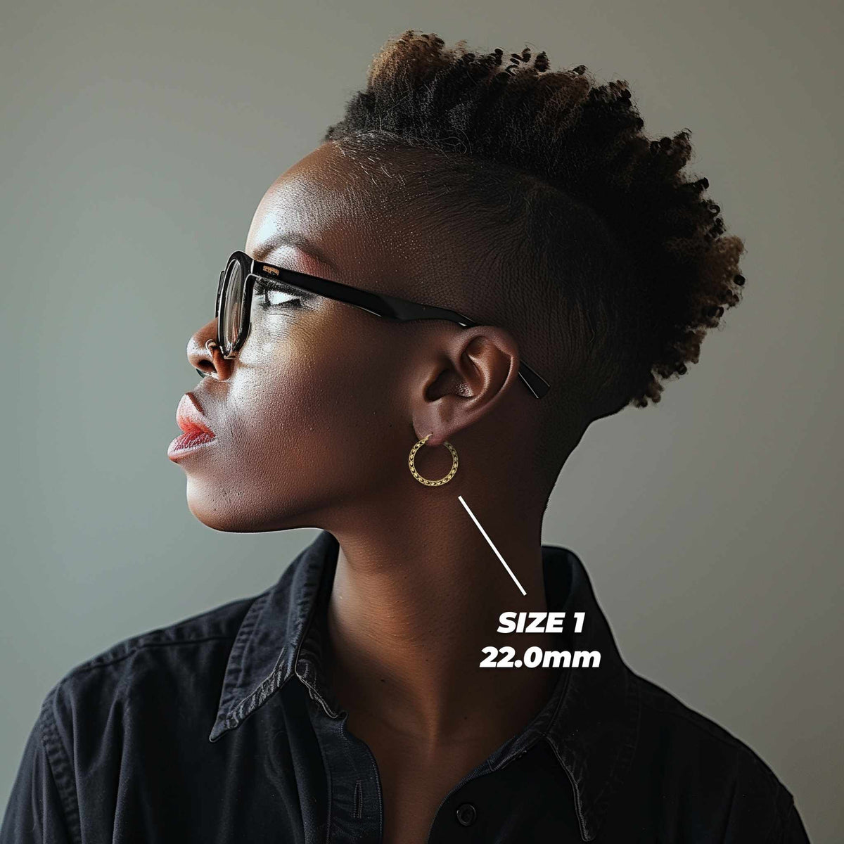 Profile view of a model wearing 22mm 10k gold Turkish hoop earrings for scale.