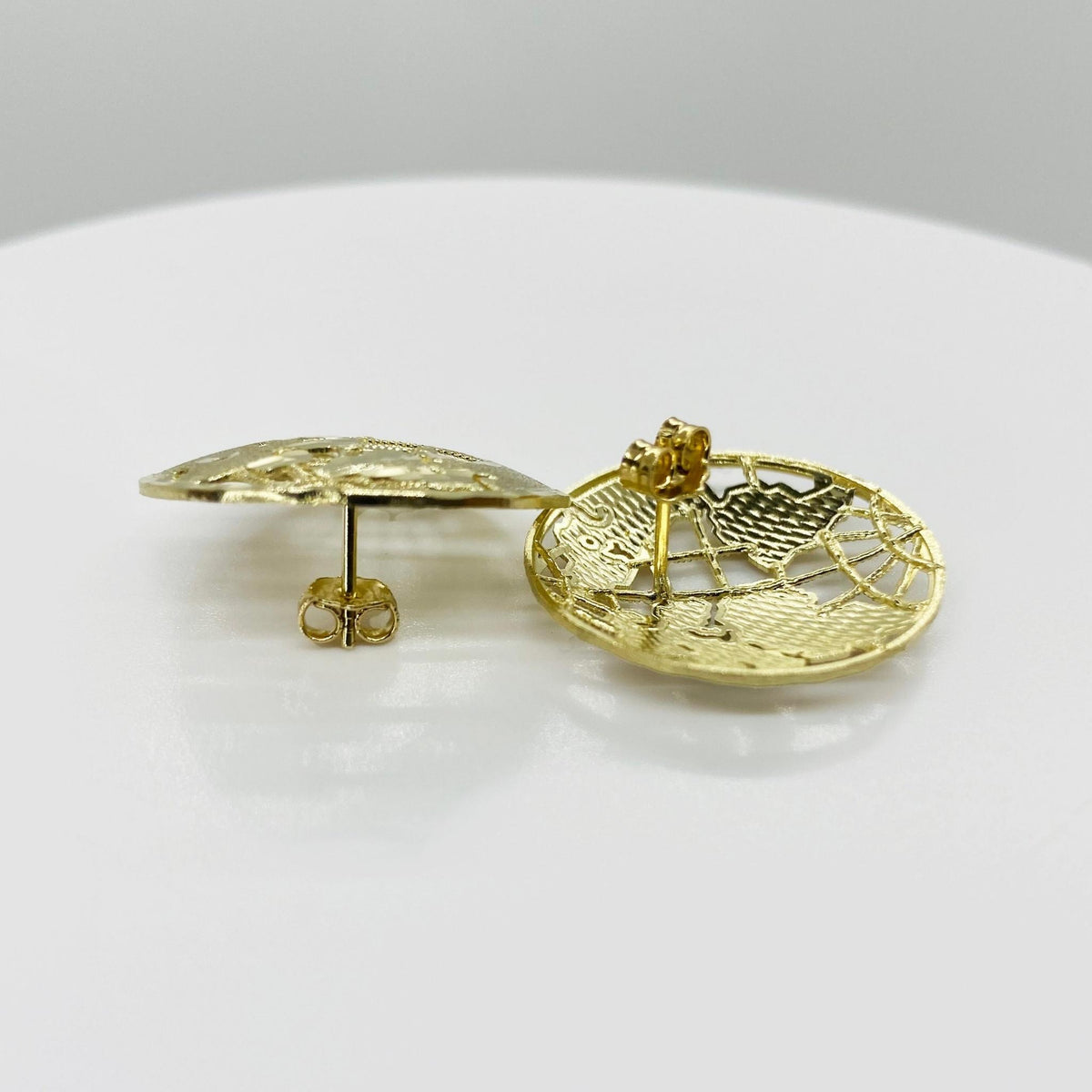 Side view of 10k gold globe stud earrings showing posts and butterfly backs.
