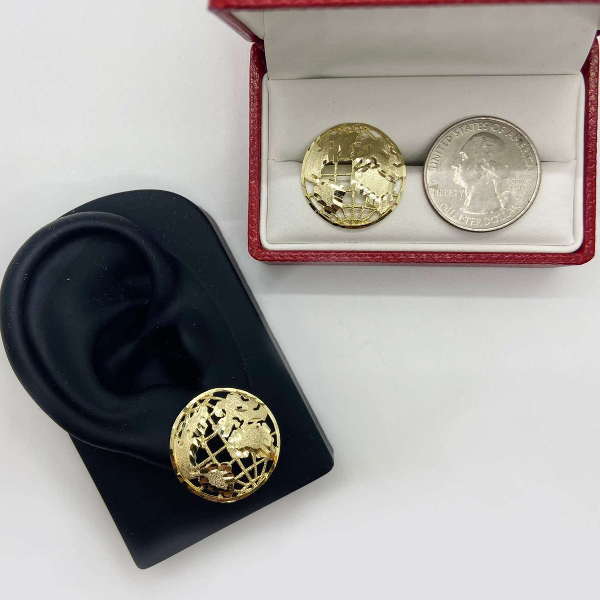 10k gold globe stud earrings on a display stand and in a jewelry box.