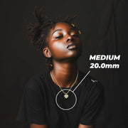 Model wearing the Medium gold heart necklace with size measurements.