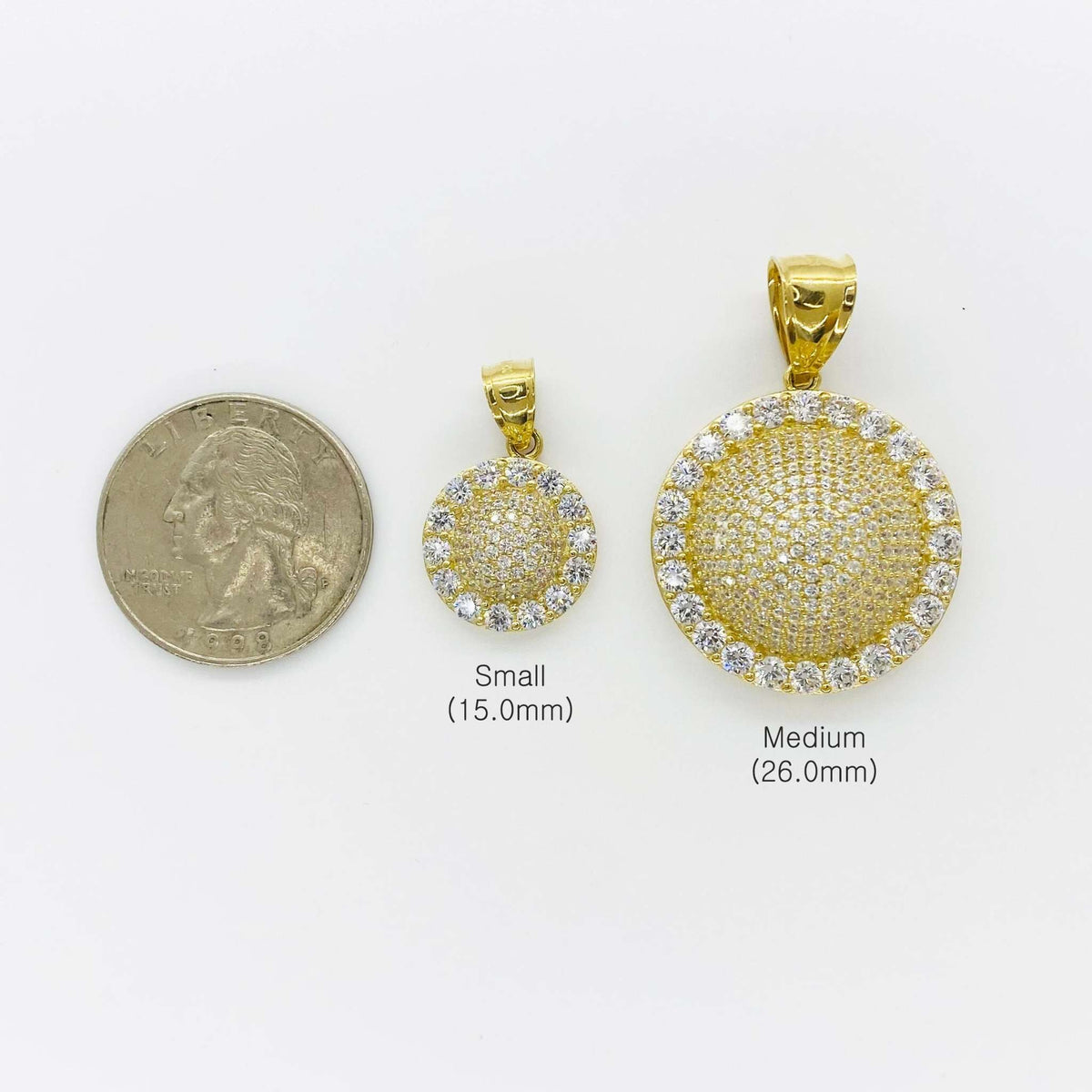 Size comparison of small 15.0mm and medium 26.0mm gold round CZ pendants next to a quarter