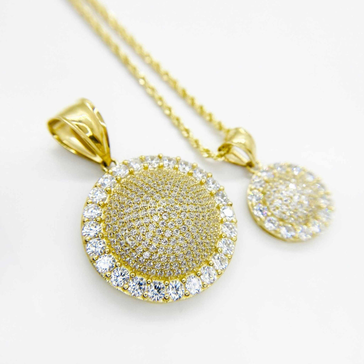 10k yellow gold convex round CZ pendants shown in medium and small sizes.