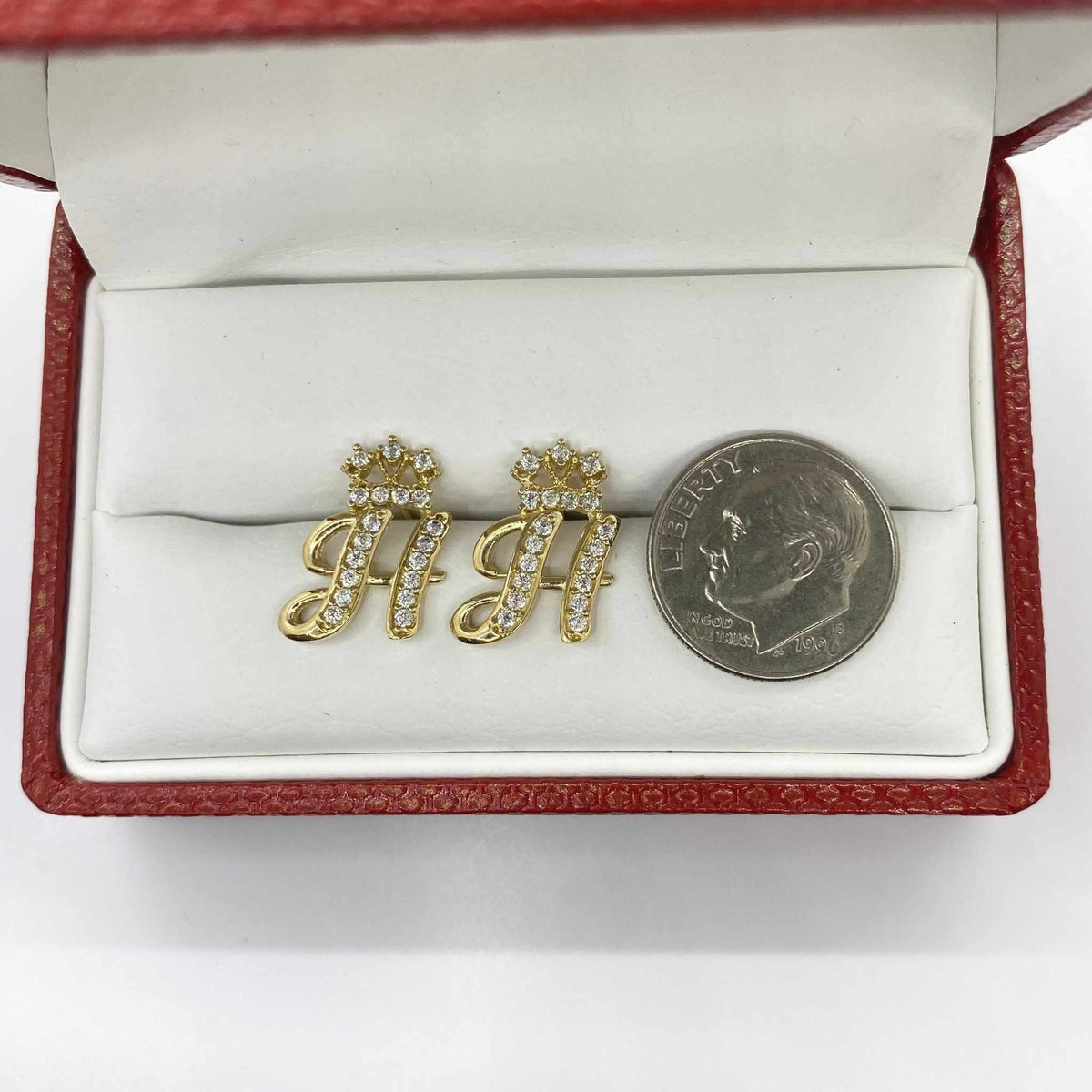 10k gold cursive letter H stud earrings with CZ crown accents beside a dime.