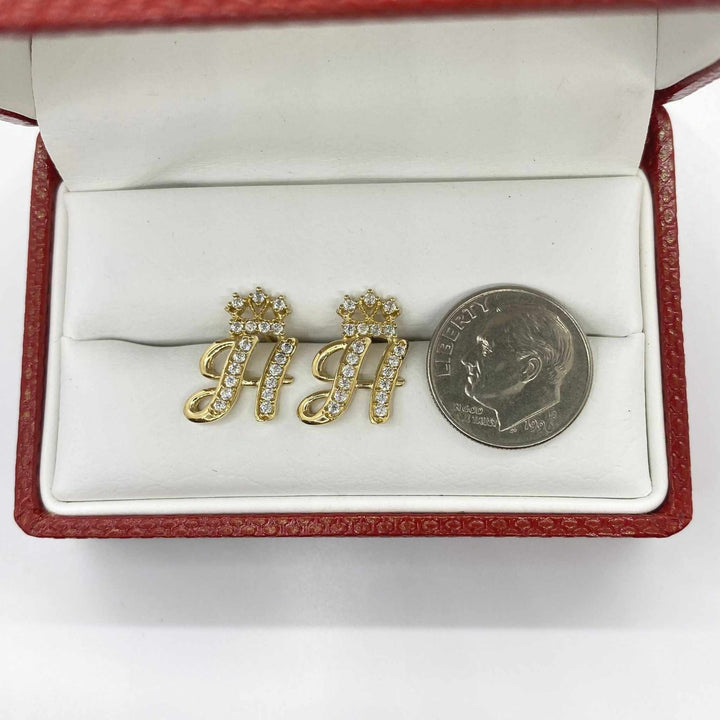 10k gold cursive letter H stud earrings with CZ crown accents beside a dime.