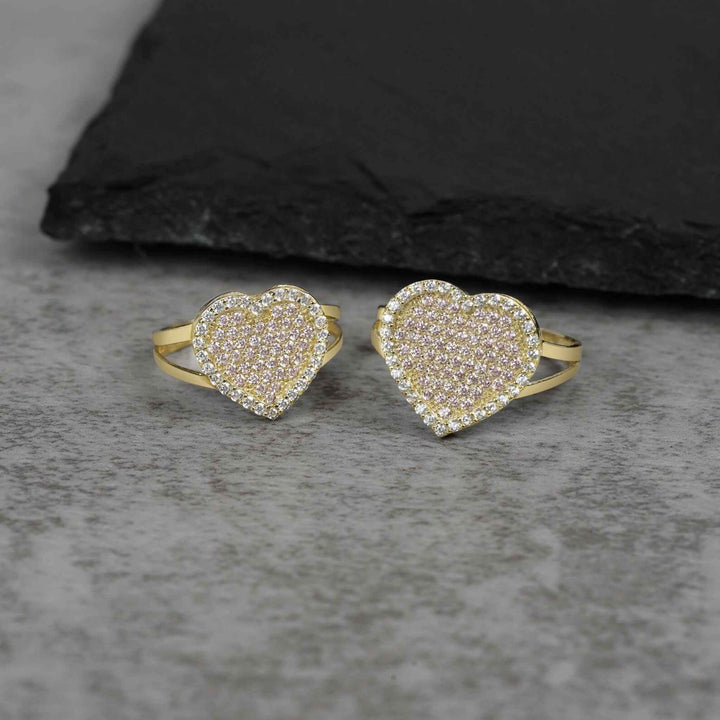 Two 10k gold heart rings of different sizes featuring pavé cubic zirconia stones.
