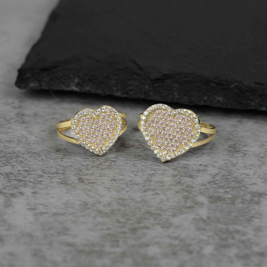 Two 10k gold heart rings of different sizes featuring pavé cubic zirconia stones.