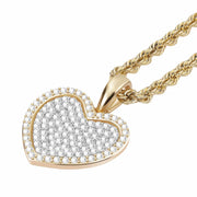 A 10k gold heart pendant paved with clear stones and attached to a rope chain.
