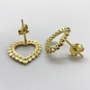 Reverse angle of 10k solid gold heart earrings, featuring diamond-cut detailing and post closures.