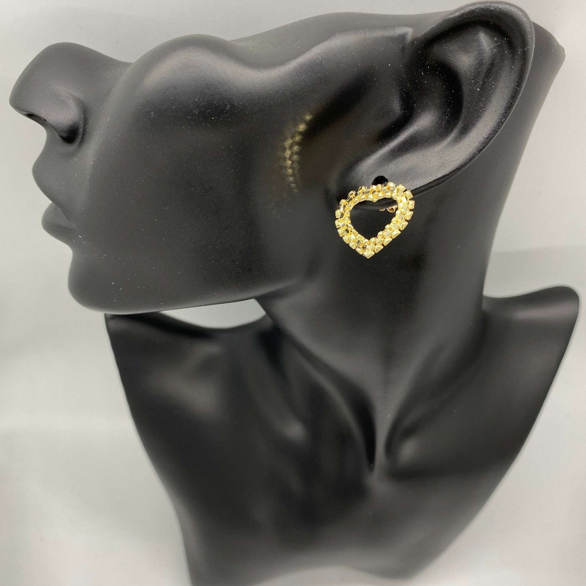 Elegant 10k solid gold heart-framed stud earring, diamond-cut rollie texture, displayed on mannequin.