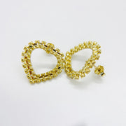Pair of 10k yellow gold diamond-cut rollie style heart stud earrings.