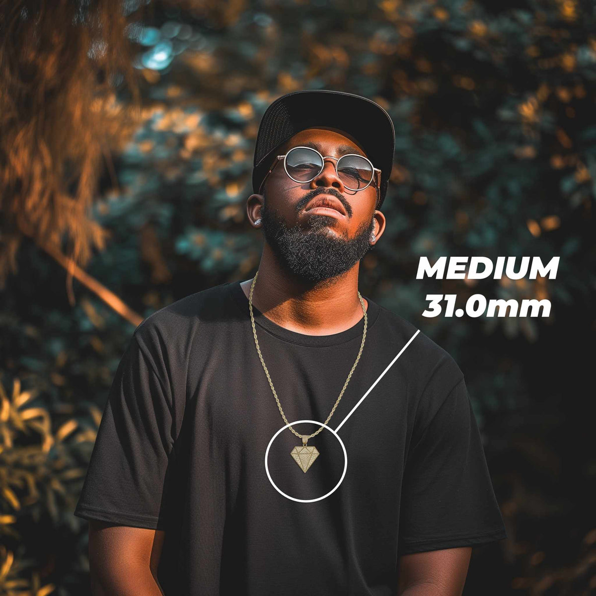 Man wearing a black t-shirt and cap modeling a 31.0mm gold diamond pendant necklace.