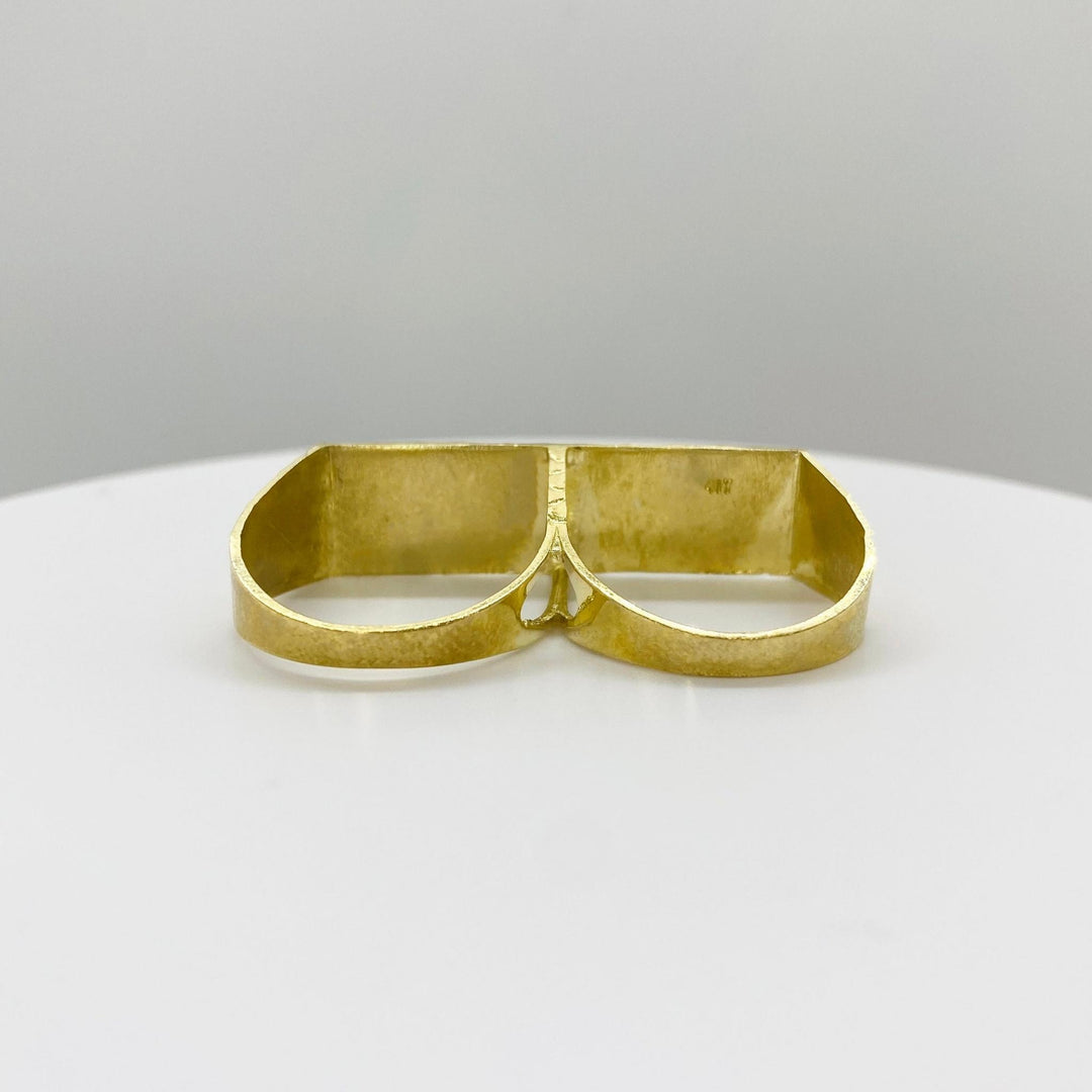 10k Gold double finger ring back view on a white plate with a gray background