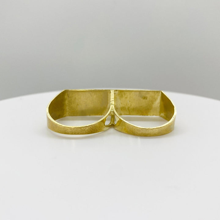 10k Gold double finger ring back view on a white plate with a gray background