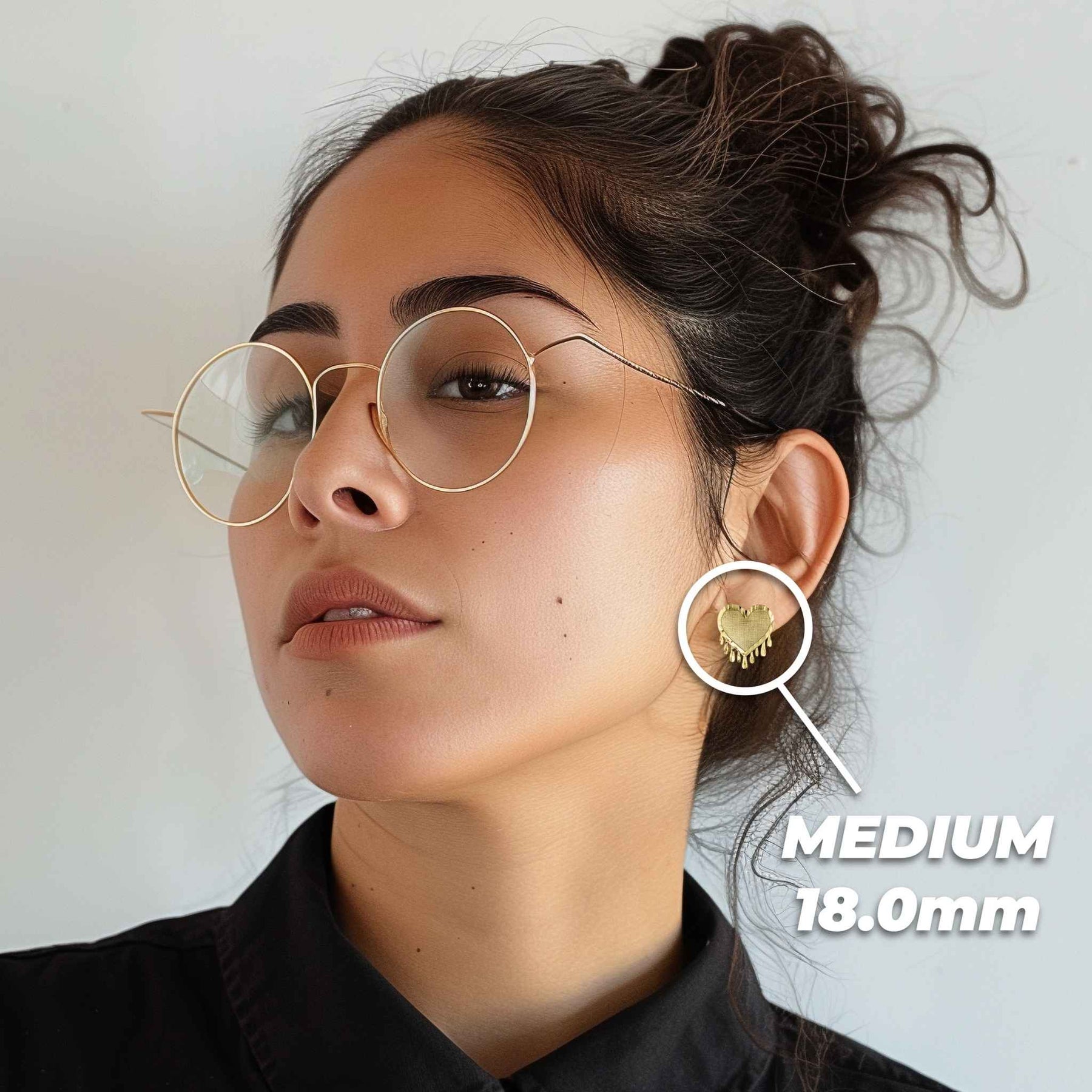 Female model wearing the 18.0mm Medium 10k gold dripping heart stud earring.