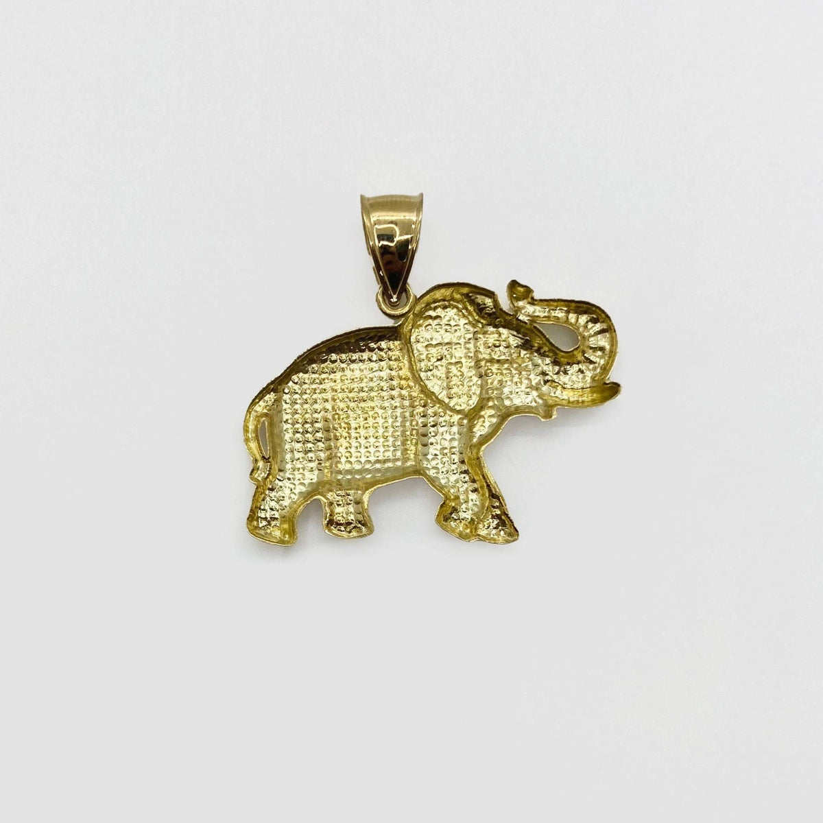 Back view of 10k gold elephant pendant showing hollow openwork texture and bail construction.