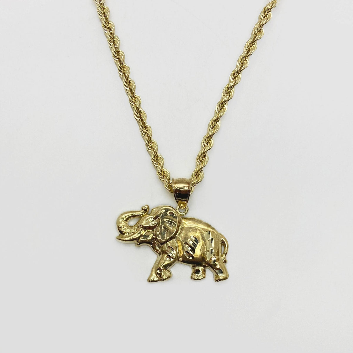 10k gold elephant diamond-cut motif pendant charm on a rope chain necklace.