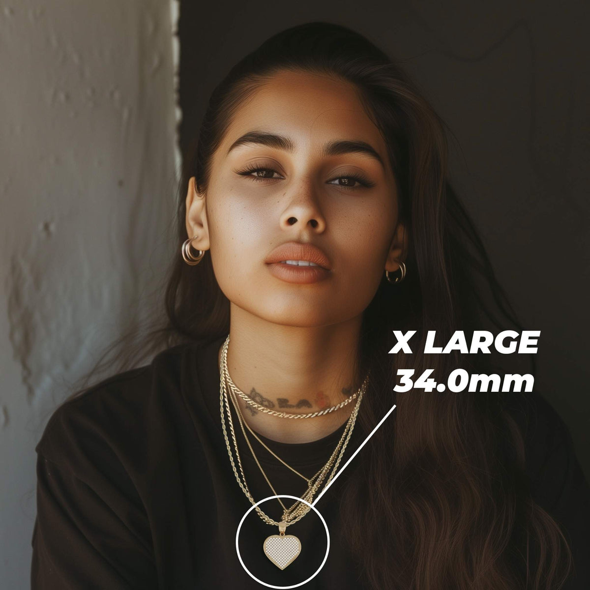 Woman wearing layered gold necklaces showcasing an X-large 34.0mm heart pendant.