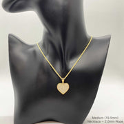 Medium gold CZ heart pendant necklace displayed on a black mannequin bust.