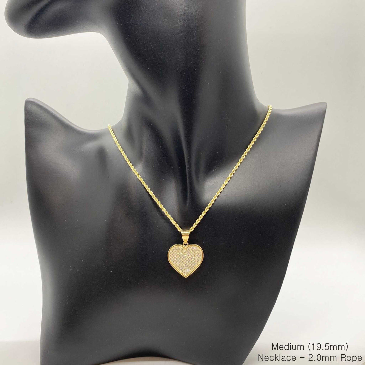 Medium gold CZ heart pendant necklace displayed on a black mannequin bust.