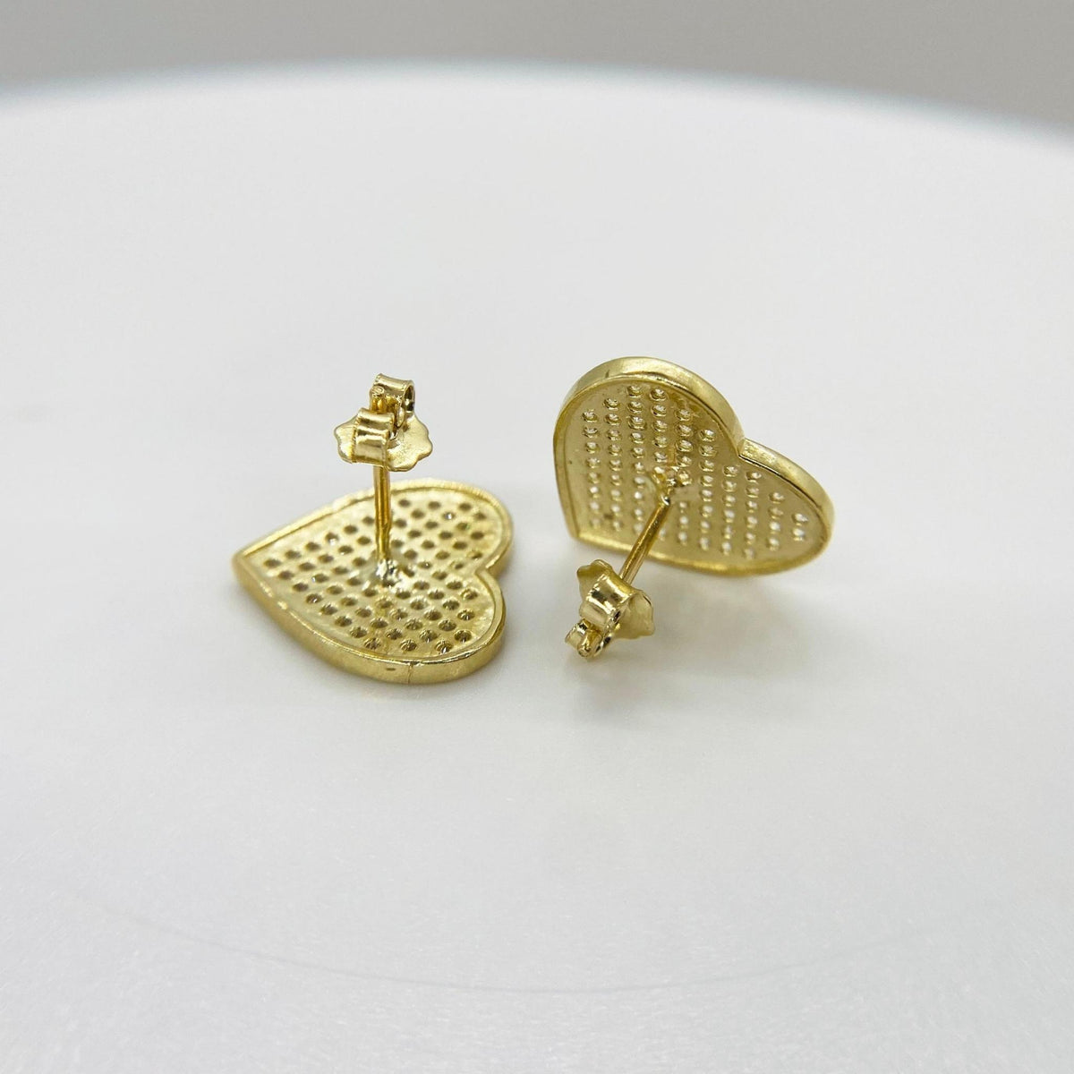 Back view of 10k yellow gold heart stud earrings showing the secure push-back closures.