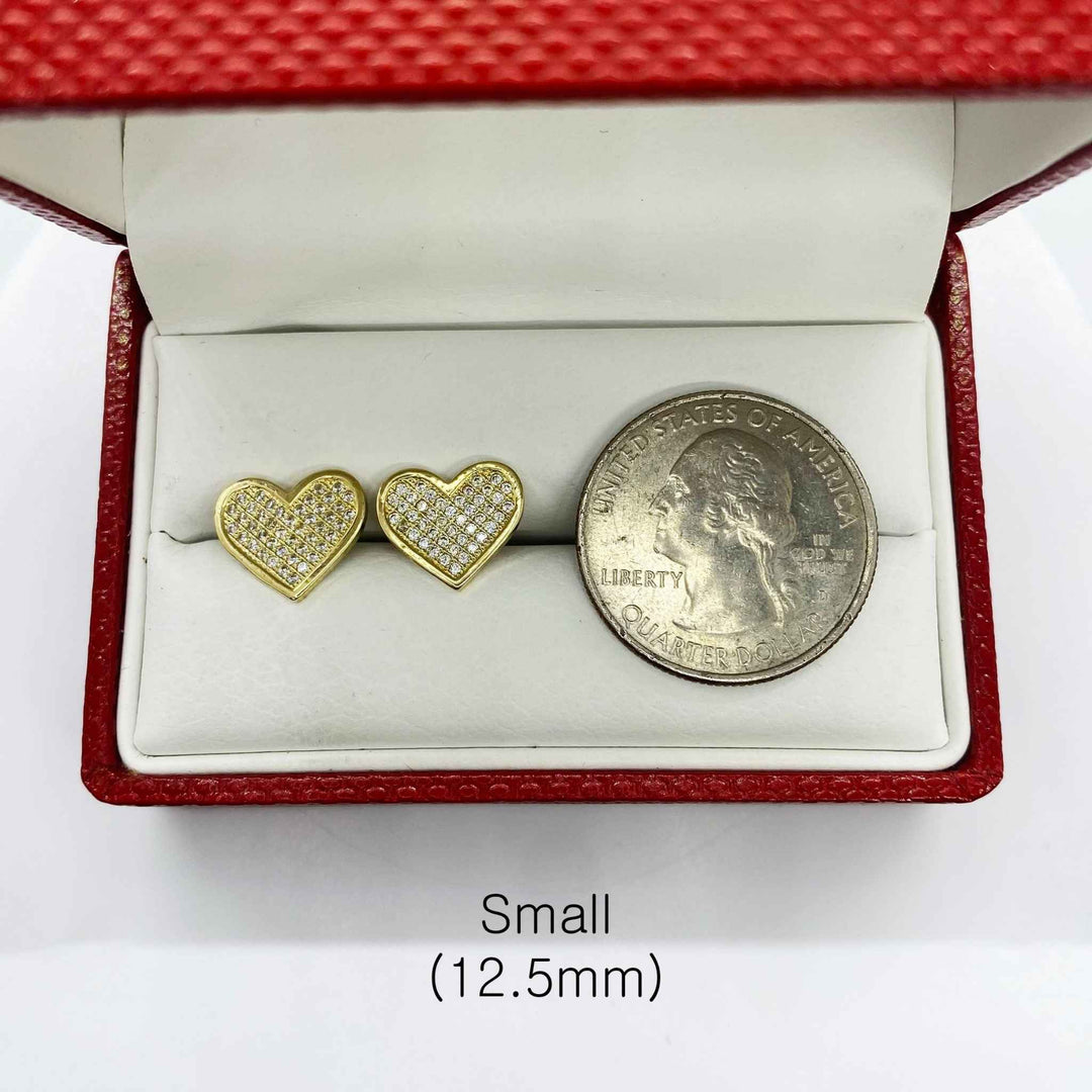 Small 12.5mm heart-shaped 10k gold CZ stud earrings shown next to a US quarter.