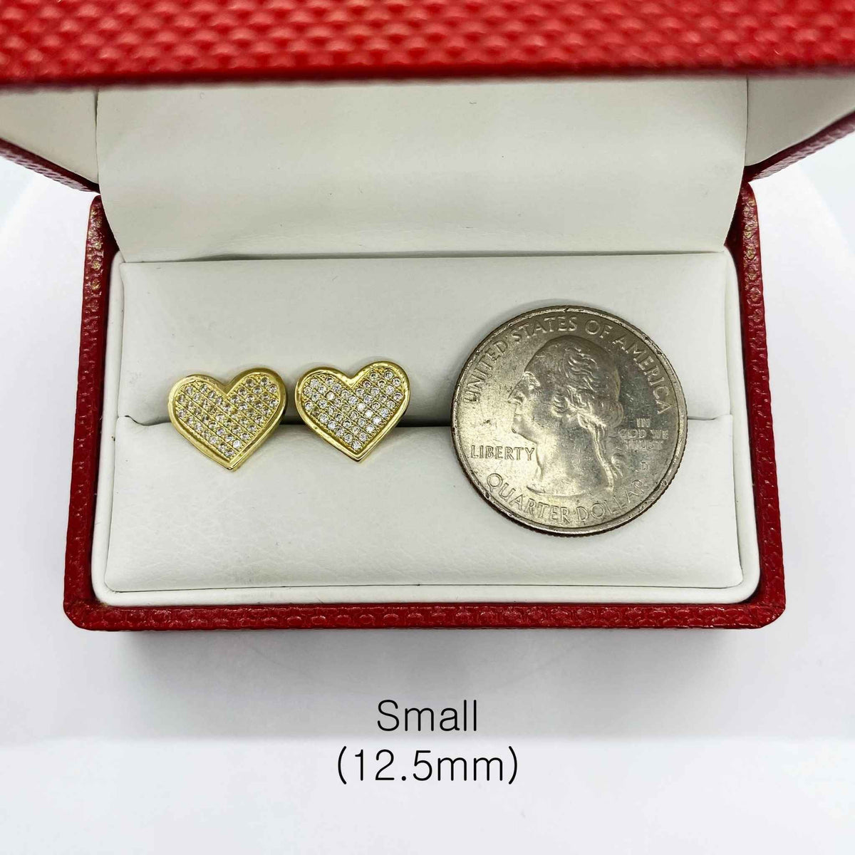 Small 12.5mm heart-shaped 10k gold CZ stud earrings shown next to a US quarter.