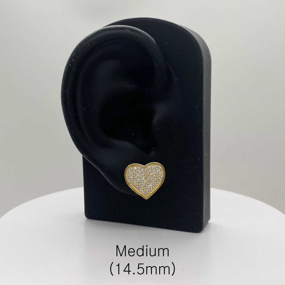 Medium 14.5mm heart-shaped 10k gold CZ stud earring displayed on a stand with size label.