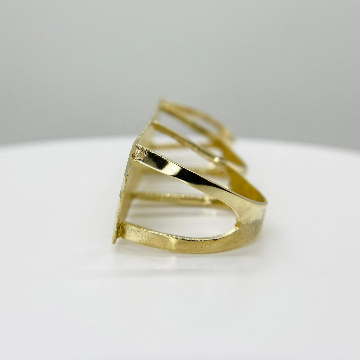 10k Gold Classic Flat Three Finger side view on white surface with a light gray background