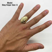 10k football shape Gold ring on a model's finger with size 8 label