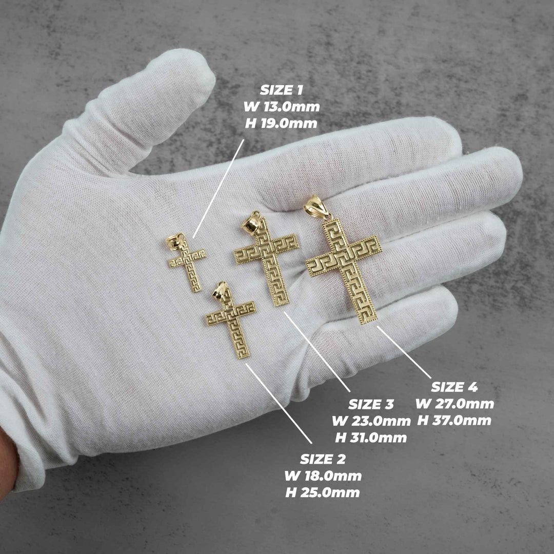 A white-gloved hand displays four gold cross pendants of varying sizes with dimension labels.