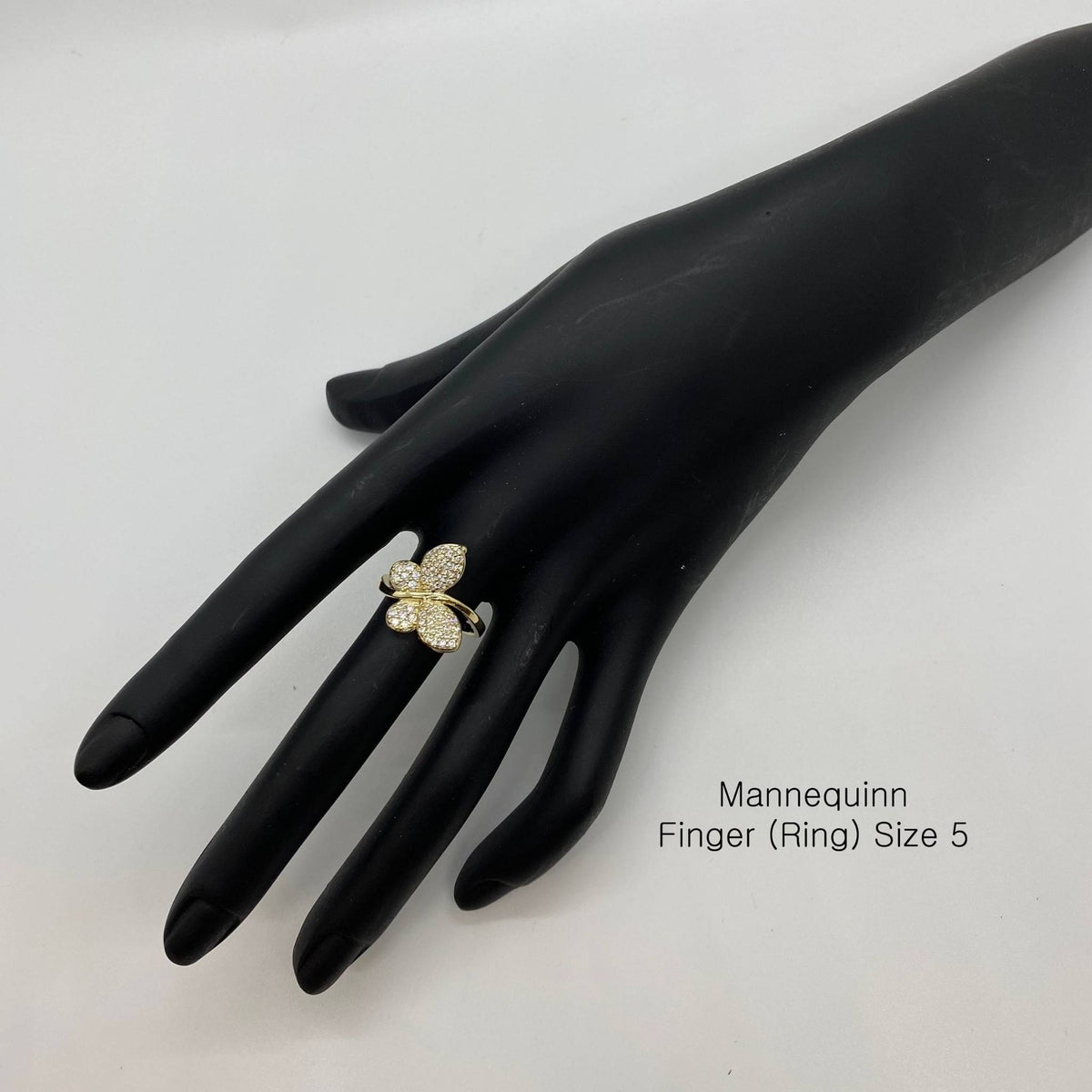 10k Gold butterfly ring on a black mannequin hand with text indicating size 5.