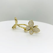 10k Gold Gleam butterfly shaped ring on a white surface with a light gray background