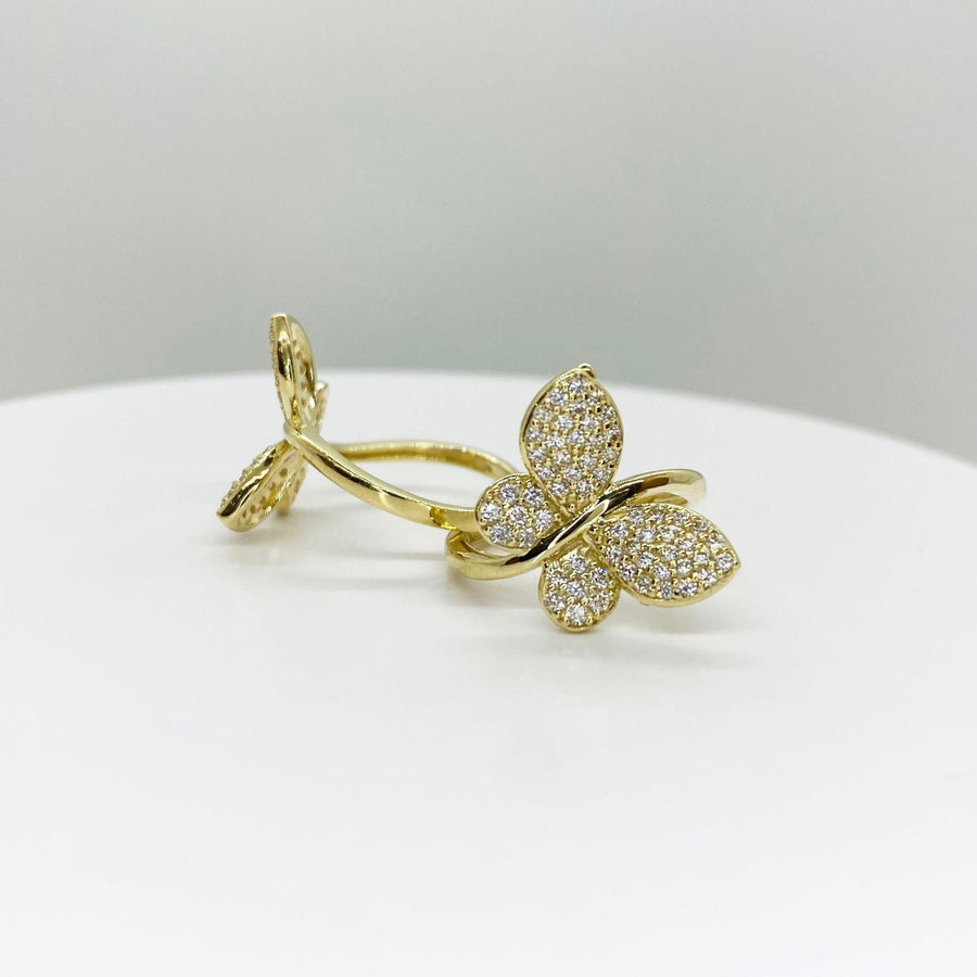 10k Gold Gleam butterfly shaped ring on a white surface with a light gray background