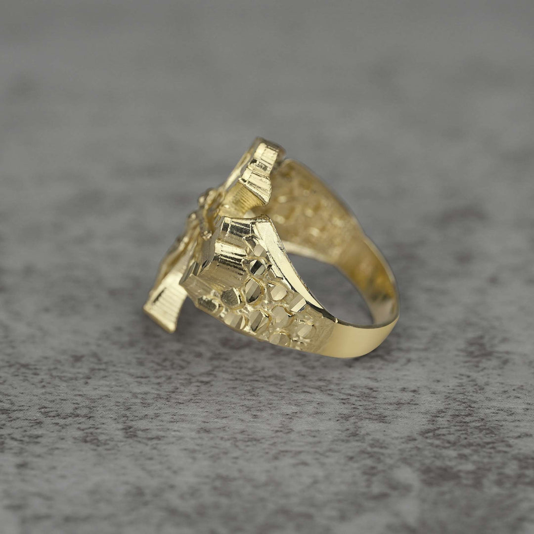 10k Gold ring with Gothic Crucifix design side view on a gray surface