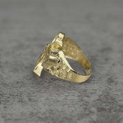 10k Gold ring with Gothic Crucifix design side view on a gray surface