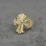 10k gold gothic crucifix nugget Ring on a gray textured background
