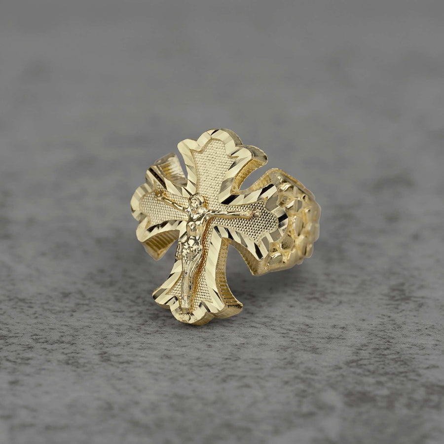10k gold gothic crucifix nugget Ring on a gray textured background