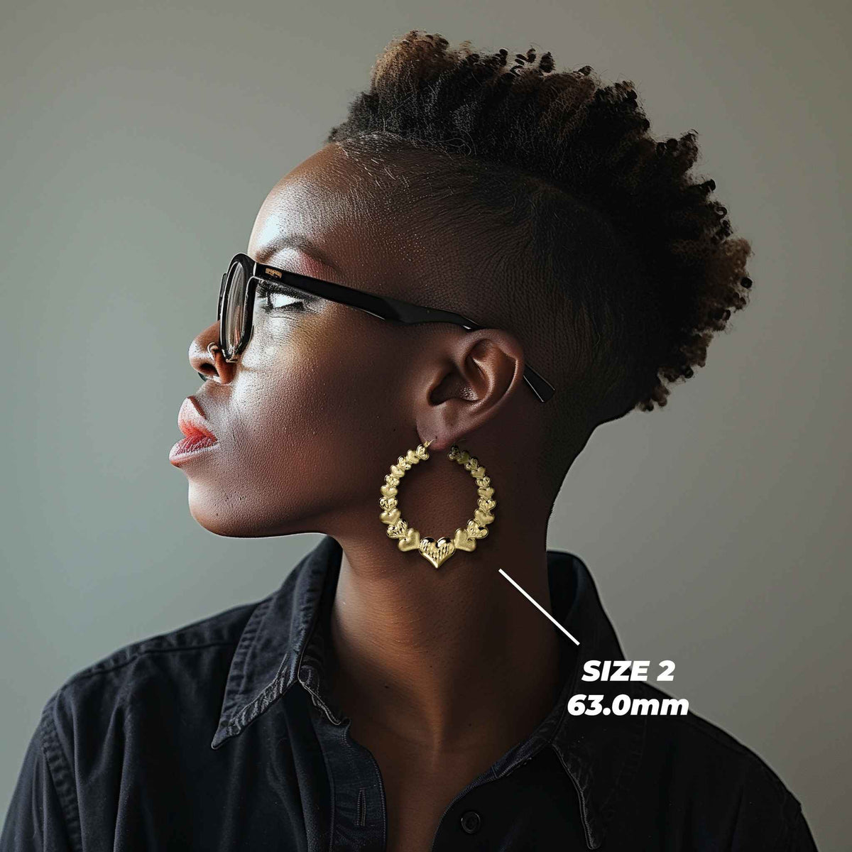 Model wearing Size 2 63.0mm 10k gold heart hoop earrings for size reference.