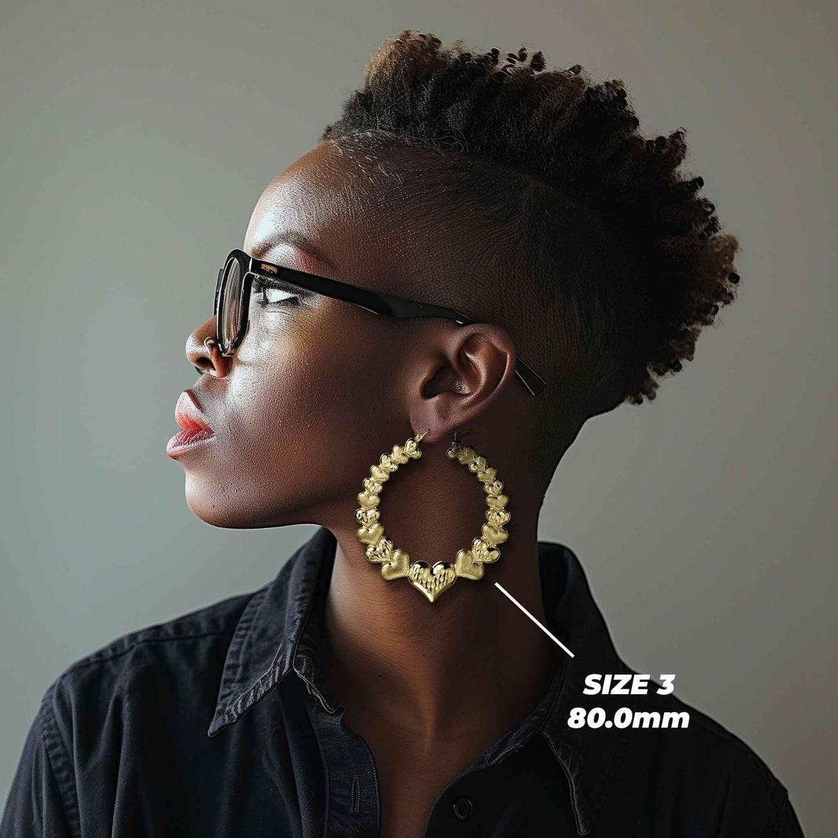 Model wearing Size 3 80.0mm 10k gold heart hoop earrings for size reference.