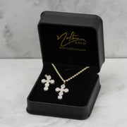 10k yellow gold cross pendant necklace and matching earrings in a black gift box.