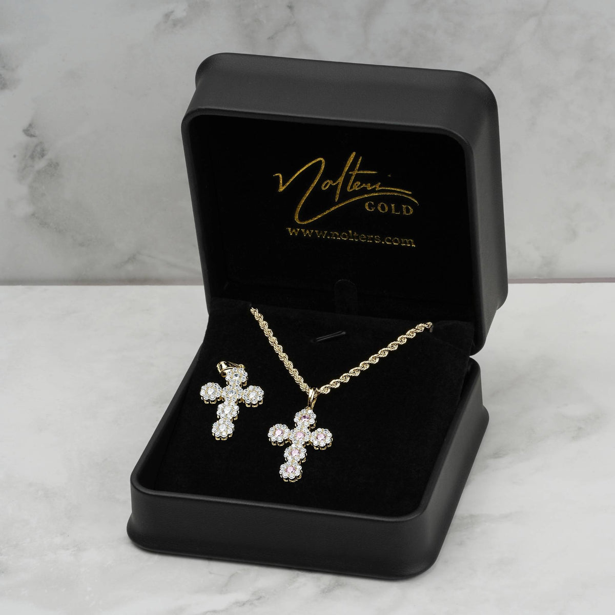Model wearing 10k yellow gold hexagon cross pendant with 27.0mm dimension overlay.