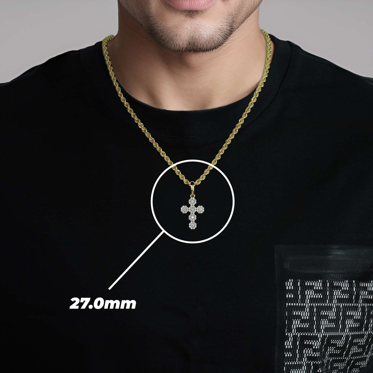 Model wearing 10k yellow gold hexagon cross pendant with 27.0mm dimension overlay.