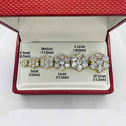 Six different sizes of gold hexagon flower cubic zirconia stud earrings arranged in a box.