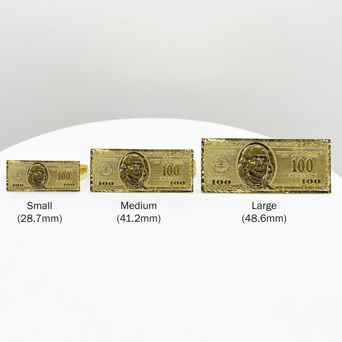 Three 10k gold rings with a hundred dollar bill design on different sizes.