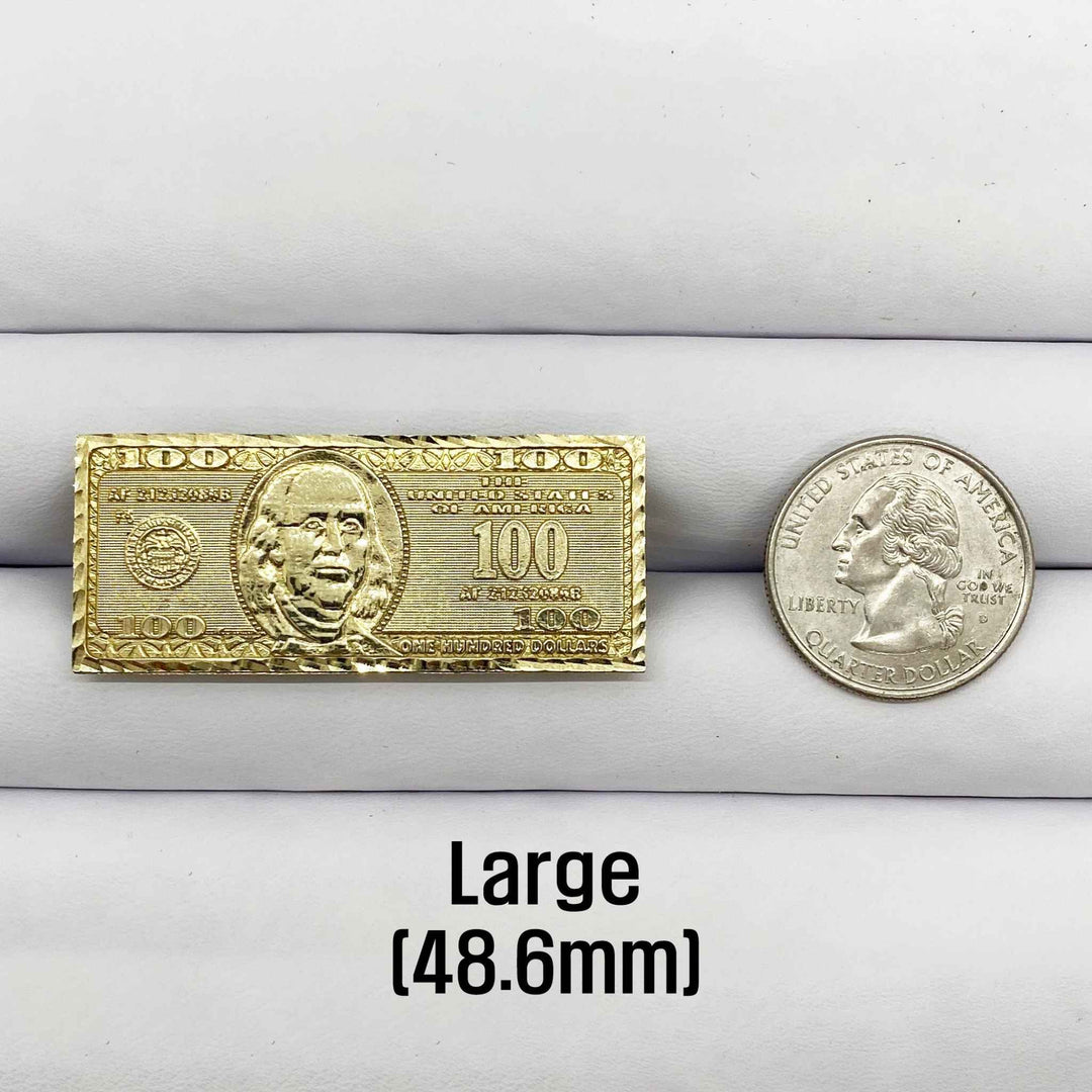 10k Gold ring with a hunderd dollar bill design next to a silver coin.