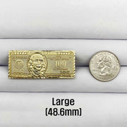 10k Gold ring with a hunderd dollar bill design next to a silver coin.